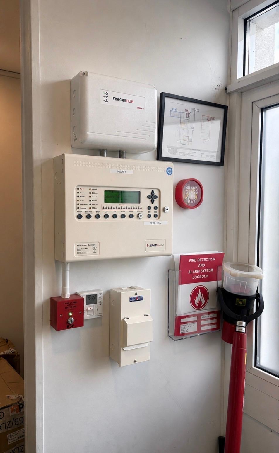 EMS FireCell wireless fire alarm control panel and hub with framed zone plan
